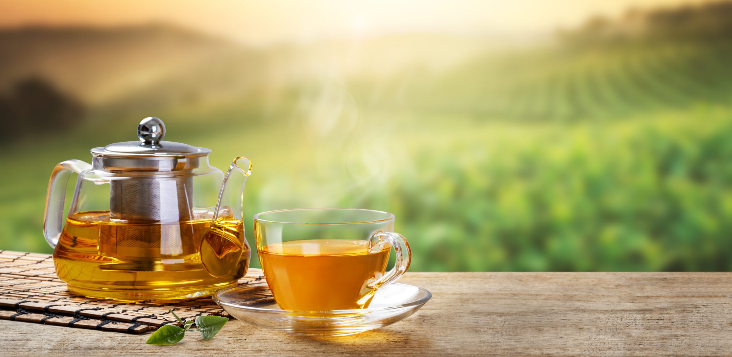 teapot, long leaves tea on the wooden desk