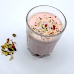 Noon Tea Also known as Kashmiri Chai in a glass with some ingredients aside