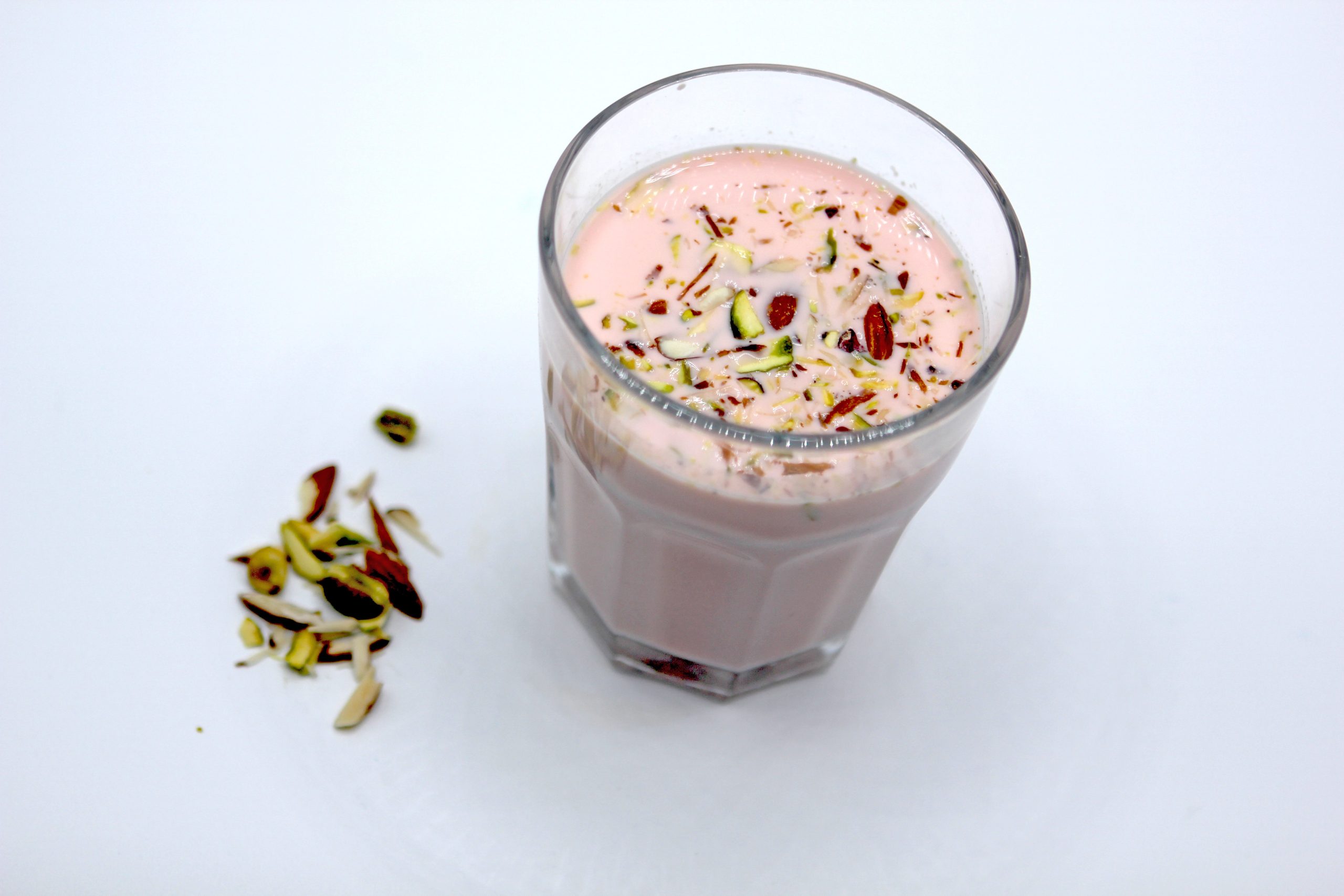 Noon Tea Also known as Kashmiri Chai in a glass with some ingredients aside