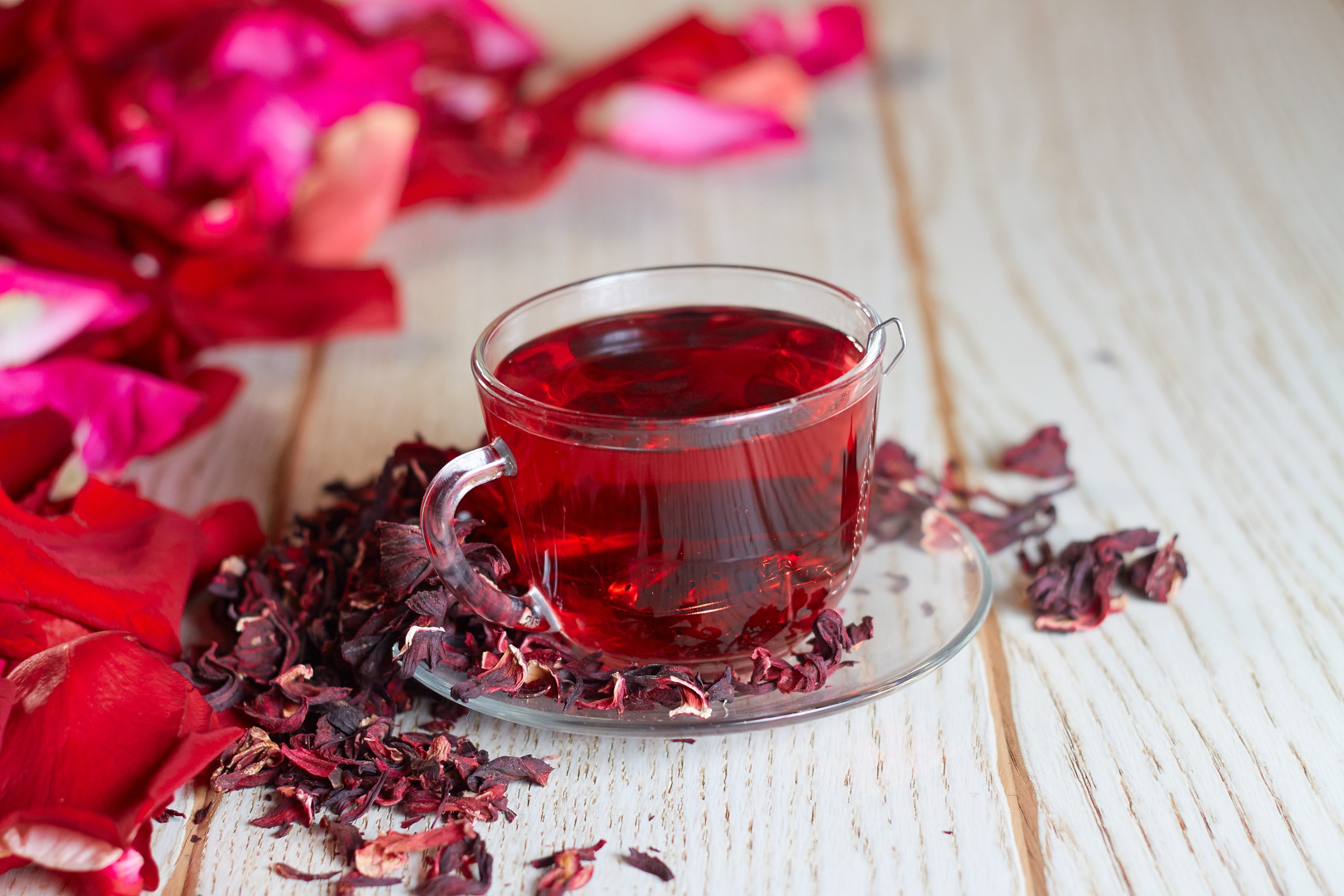 Red Hot Hibiscus tea in a glass mug on a wooden